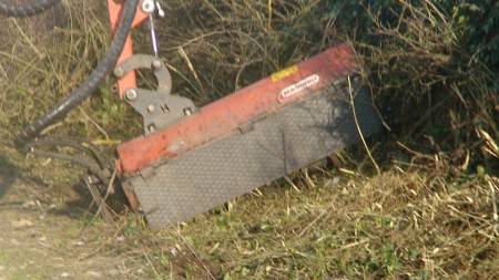 maquina picadora treballant en un camí rural